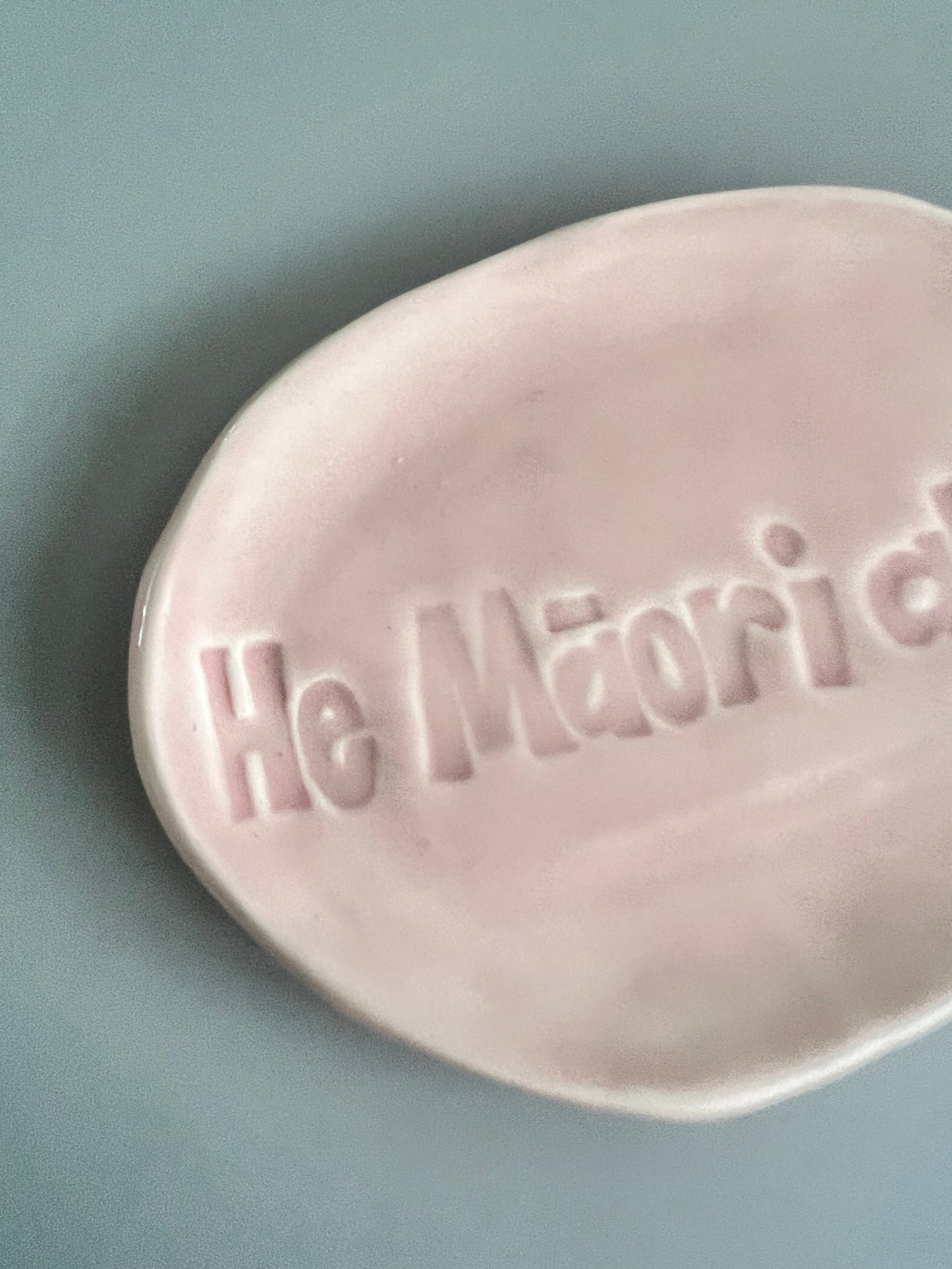 He Māori ahau trinket in baby pink