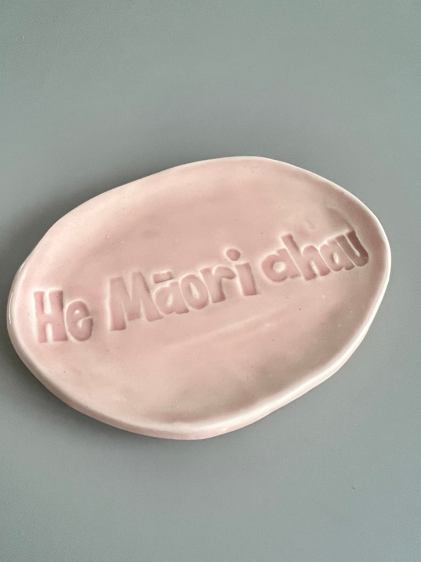 He Māori ahau trinket in baby pink